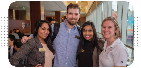 Four students smiling together.