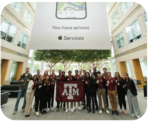 Group of students holding a Texas A&M banner in front of Apple.