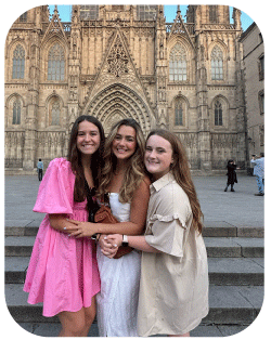 Three students smile on study abroad.