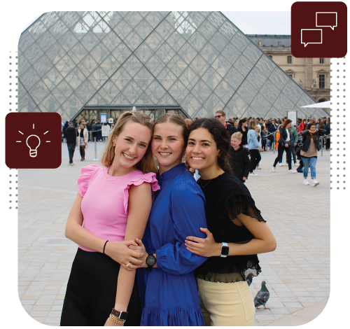 Three students pose in front of the Louvre Museum in Paris, France.