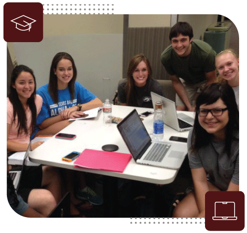 Students doing work around a table.