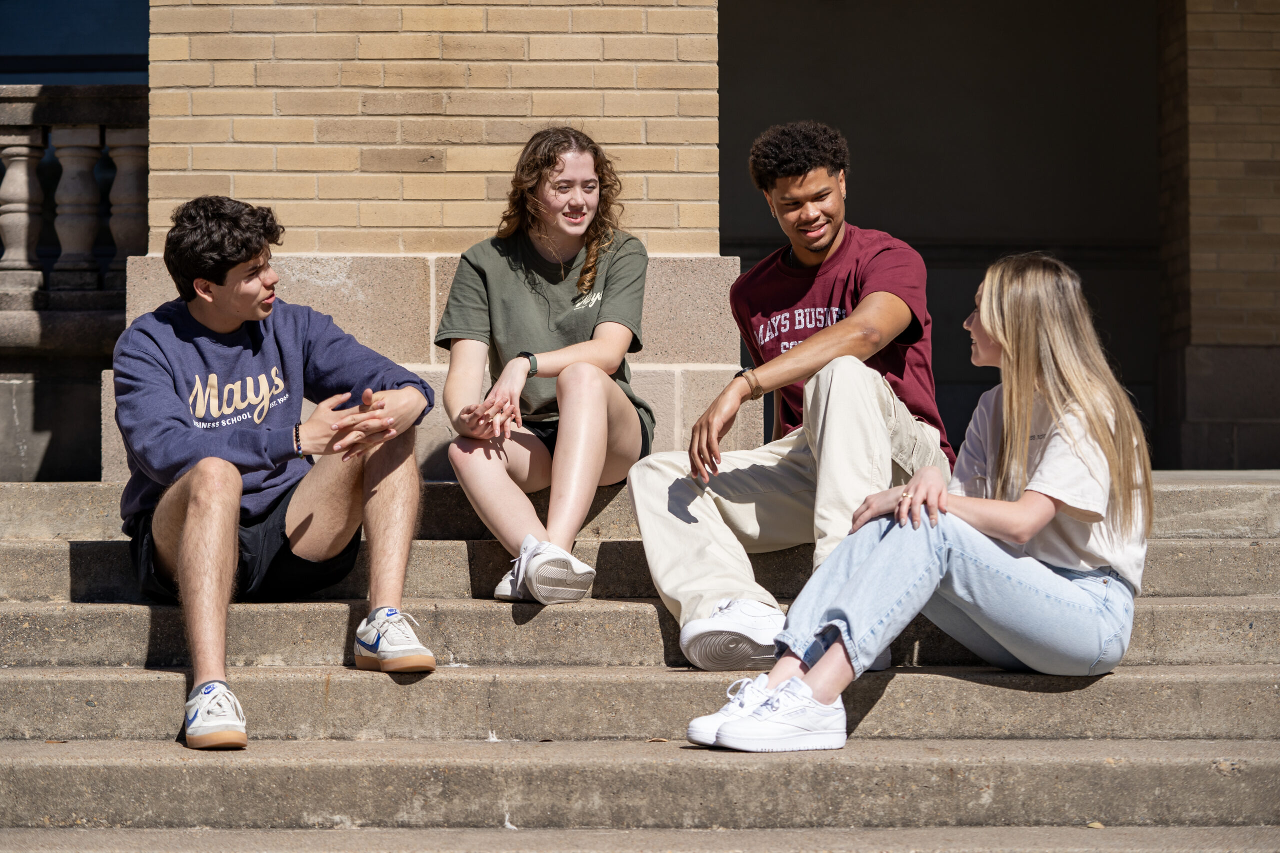 Group of people talking and smiling.