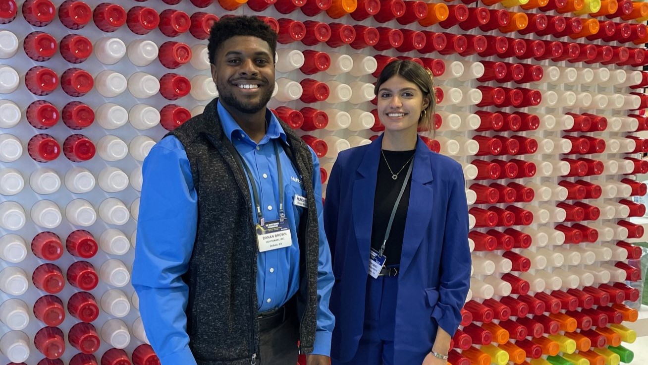 A man and a woman clicking picture at a photobooth