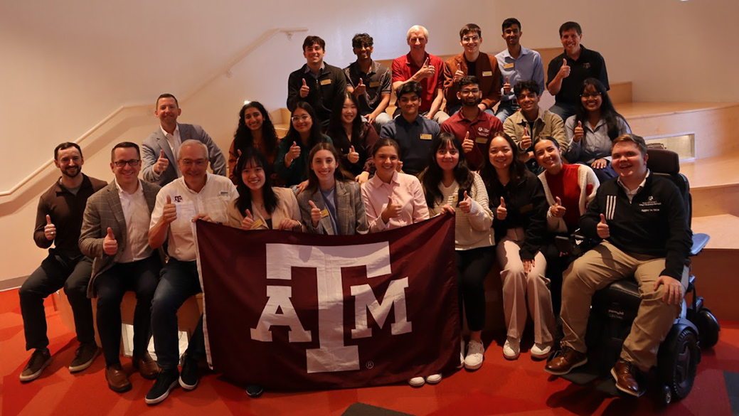 Students with Texas A&M University Flag.