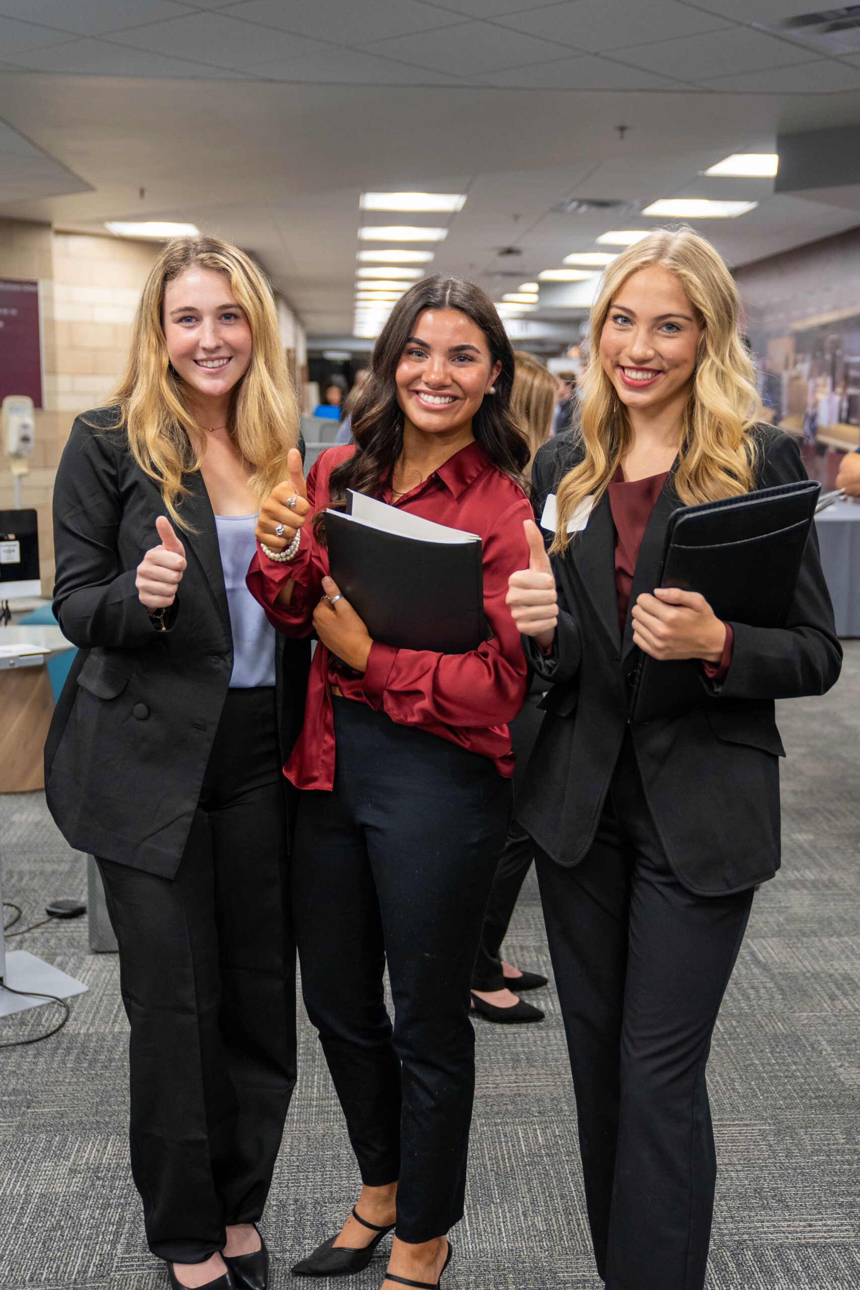 Four students smiling together.