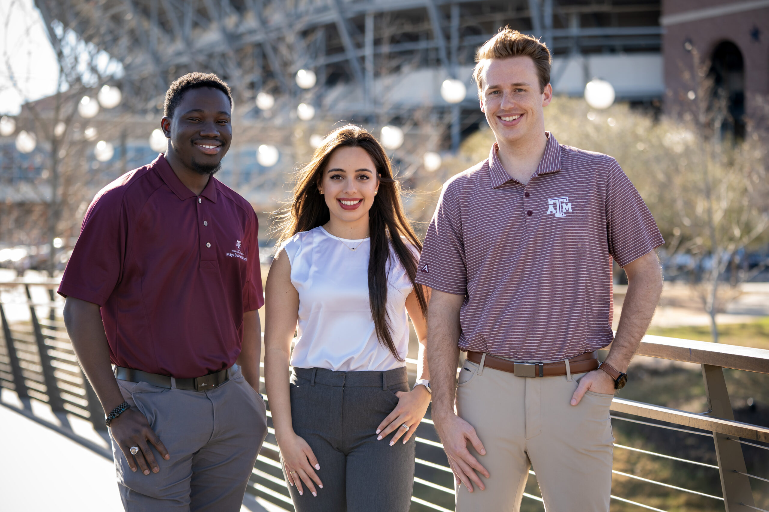 three students standing outside