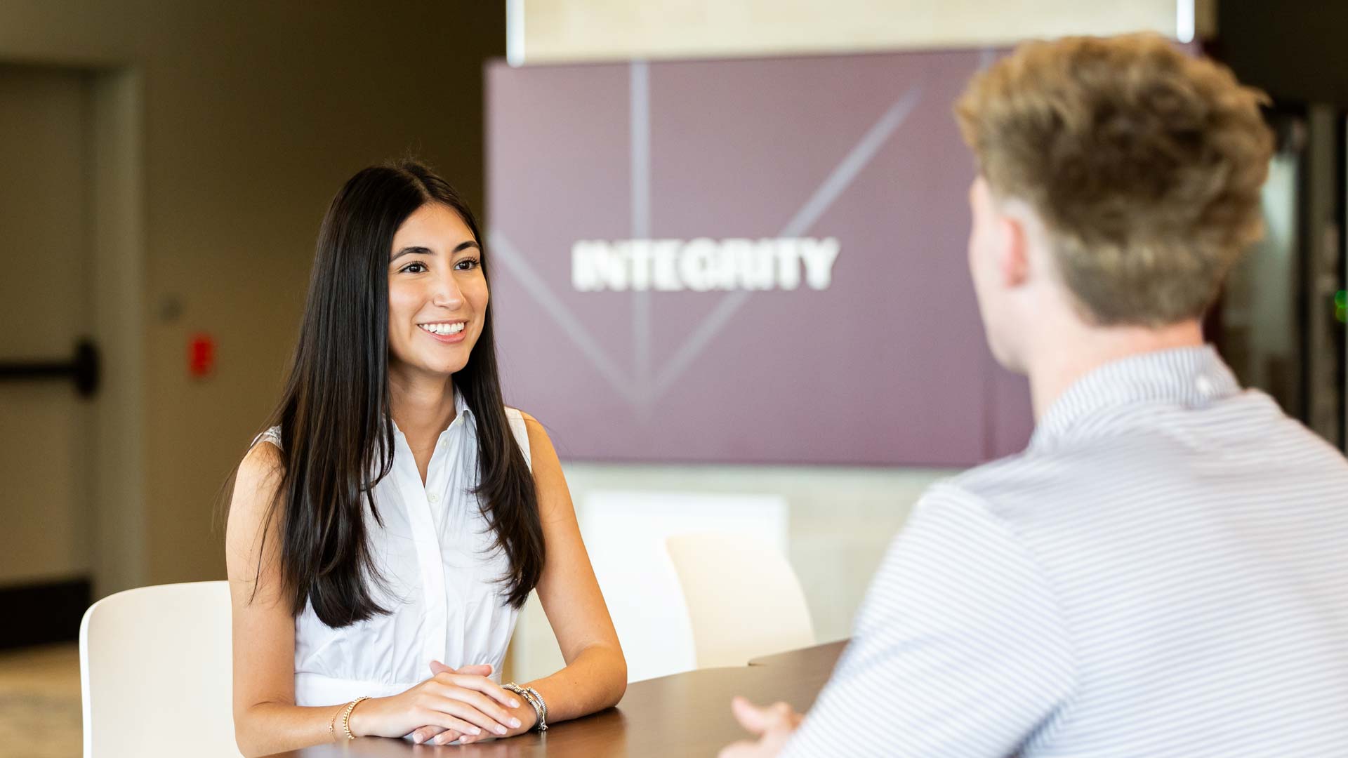 uni-110 Three women posing at the Women's Leadership Initiative conference.