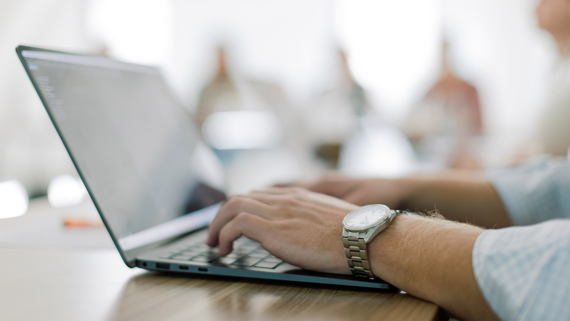 a pair of hands working on a laptop