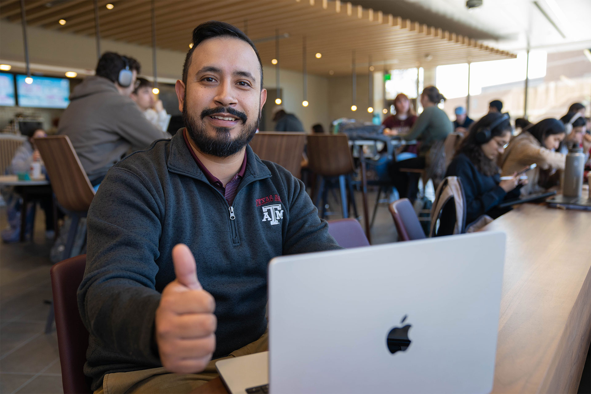 Student holding up a thumbs up
