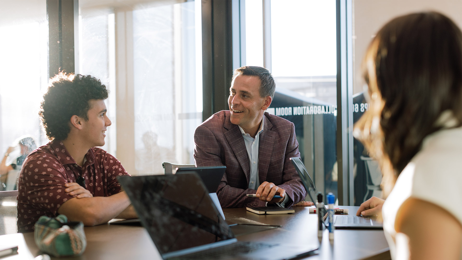 A group of sales students discussing at a table