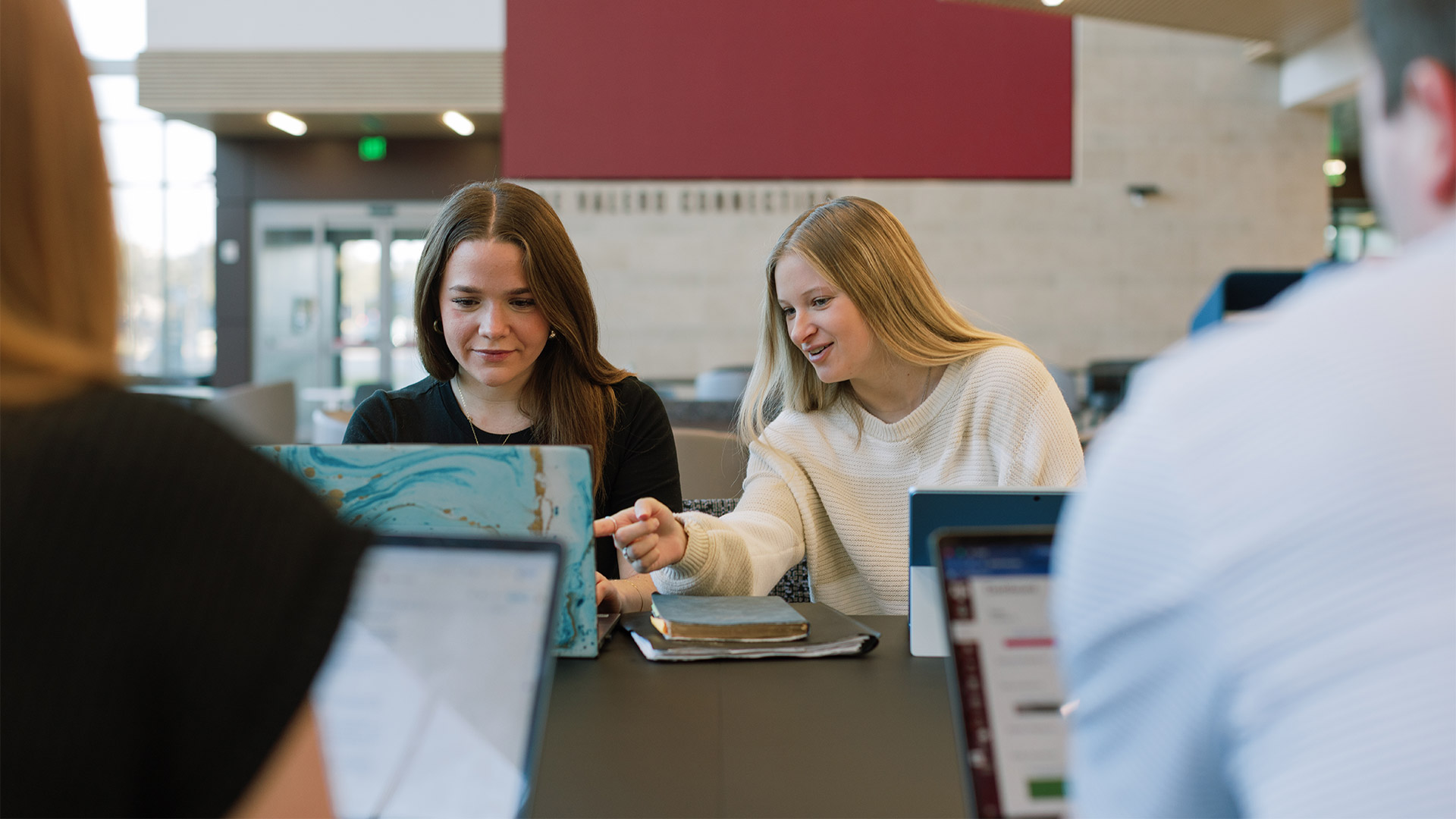 Two girls working on their laptop