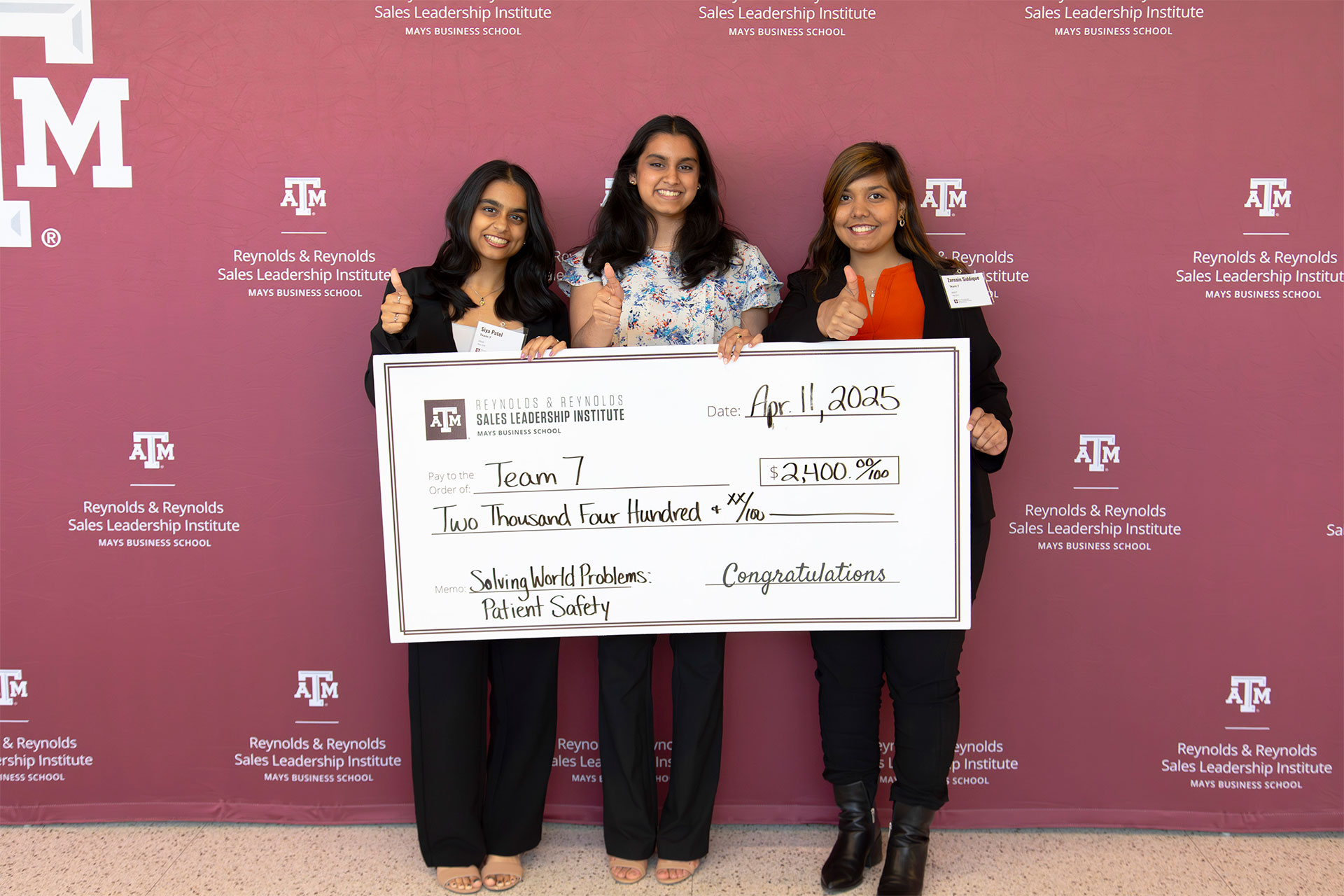 Winners of the sales competition holding the reward