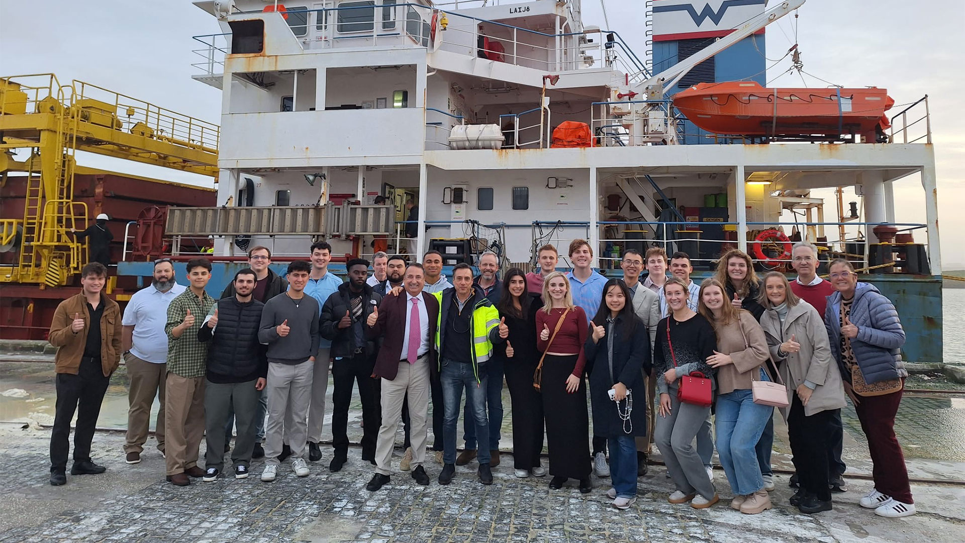 Students posing at a harbour