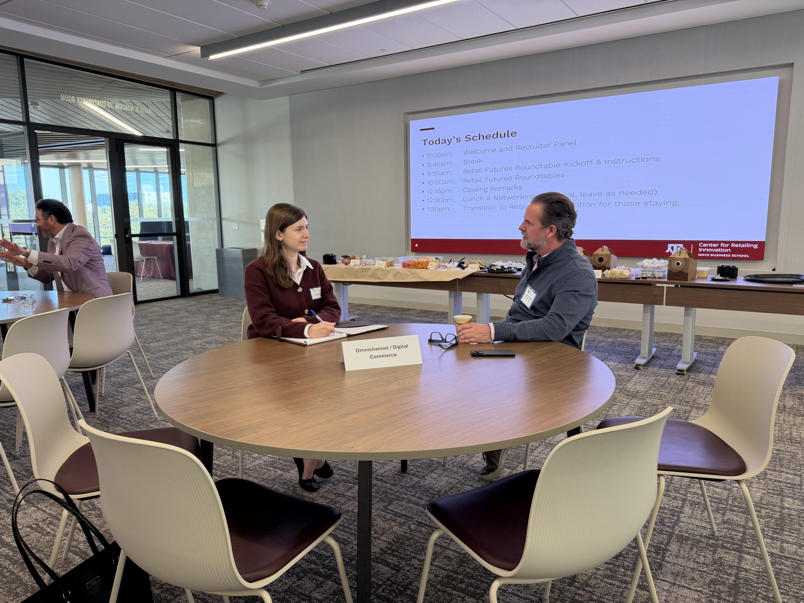 A mentor and a retailing student meet at a table